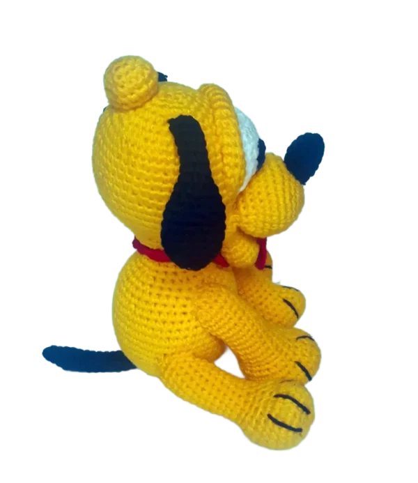 Perfil derecho del muñeco Baby Pluto amigurumi, mostrando su hocico tejido sobresaliente y la curvatura de su oreja.